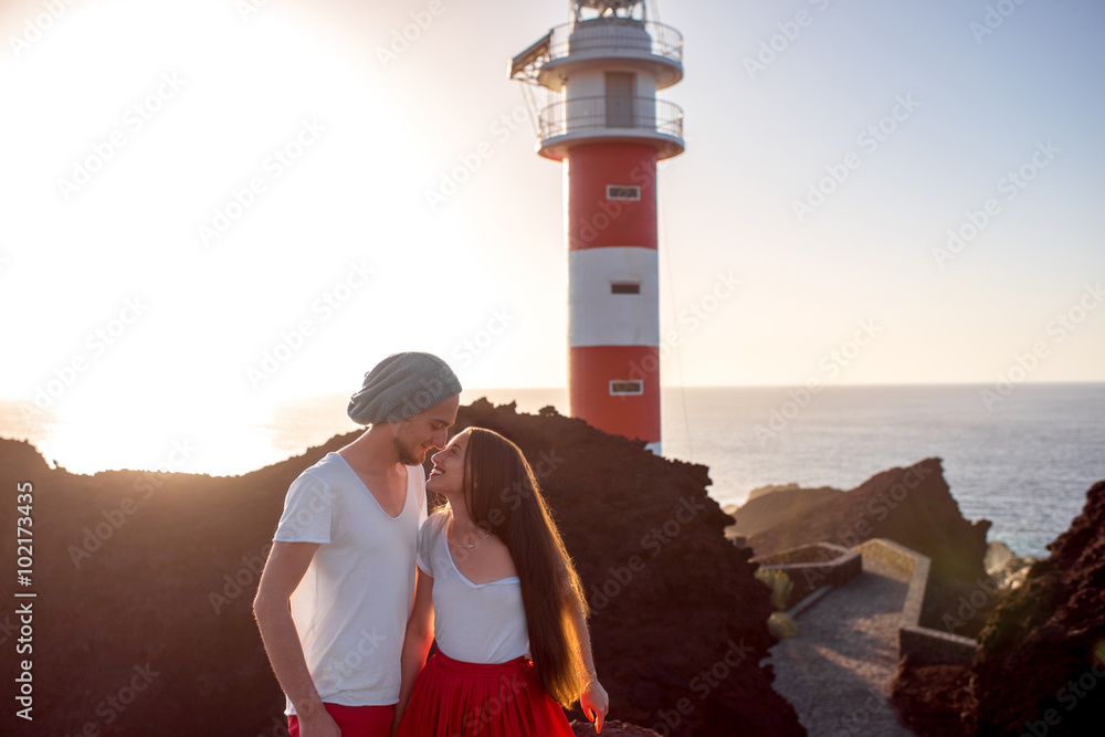 Couple standing together near the lighthouse