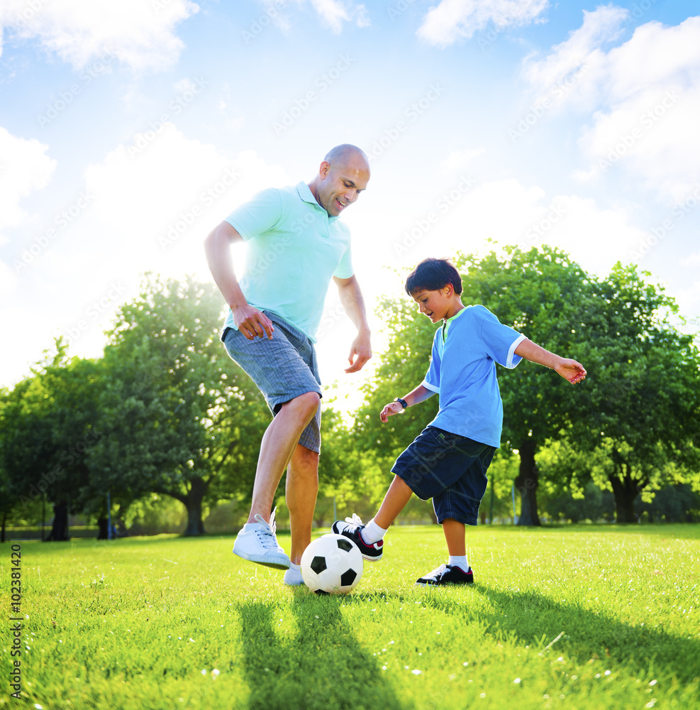 Little Boy Playing Soccer With His Father Concept