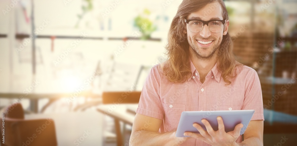 Composite image of portrait of hipster using digital tablet