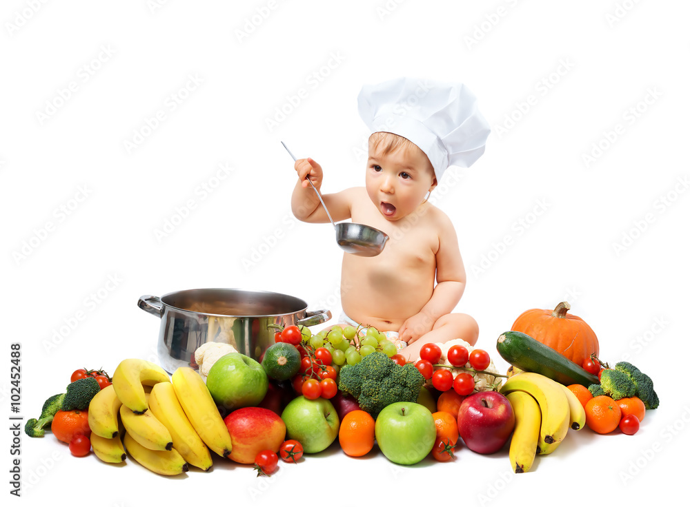 Baby boy in chef hat with cooking pan and vegetables