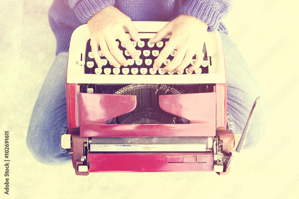 Hipster girl with old style typewriter