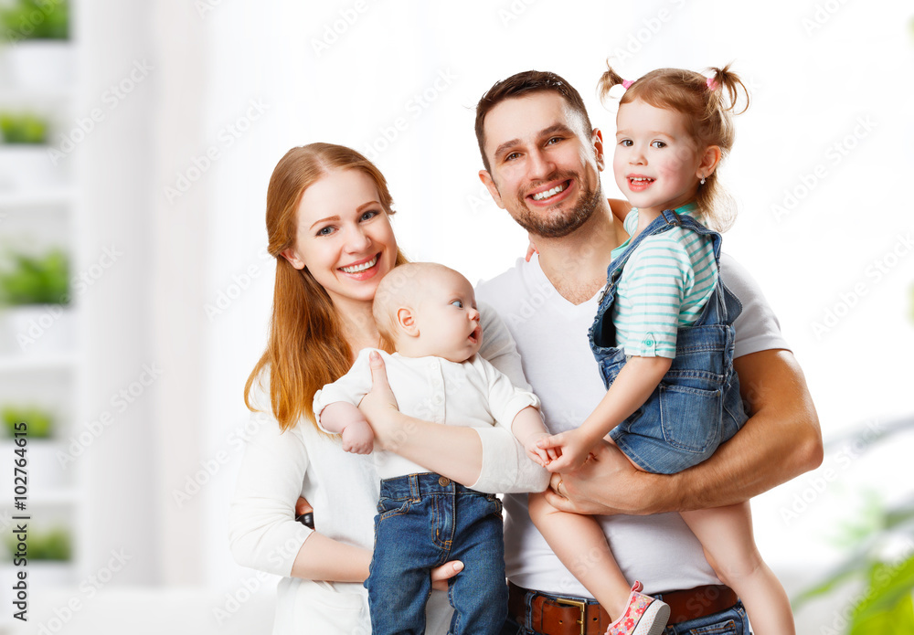 happy family mother, father and children at home