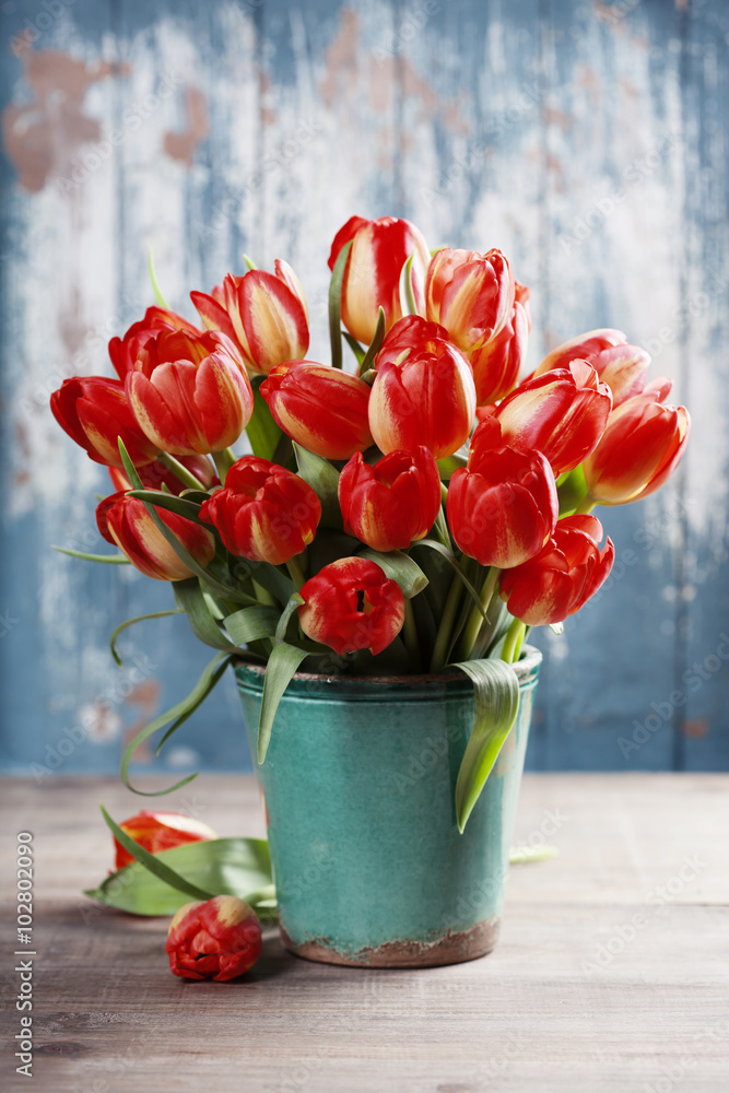 Beautiful tulips bouquet on wooden table