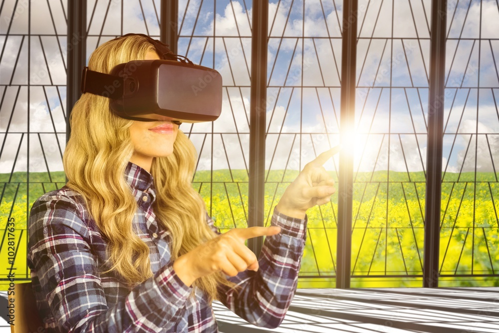 Composite image of pretty casual worker using oculus rift