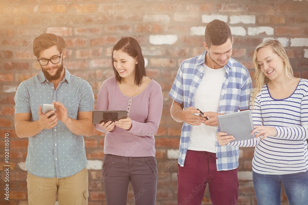 Composite image of business people using electronic gadget