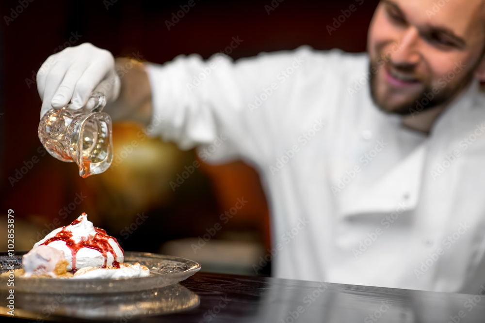 Chef cook serving dessert to the client