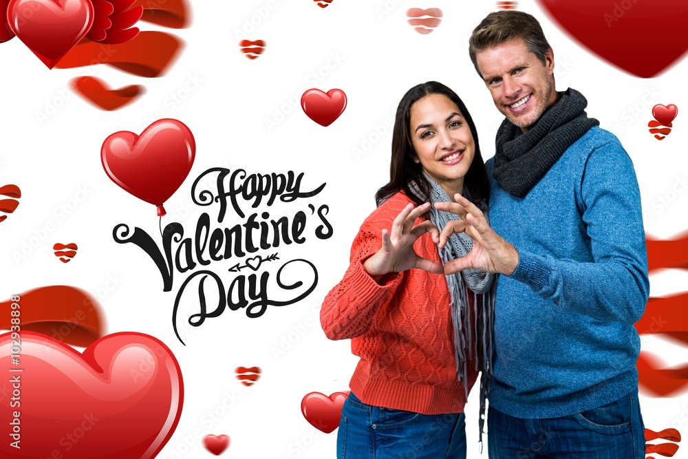 Composite image of smiling couple making heart shape with hands