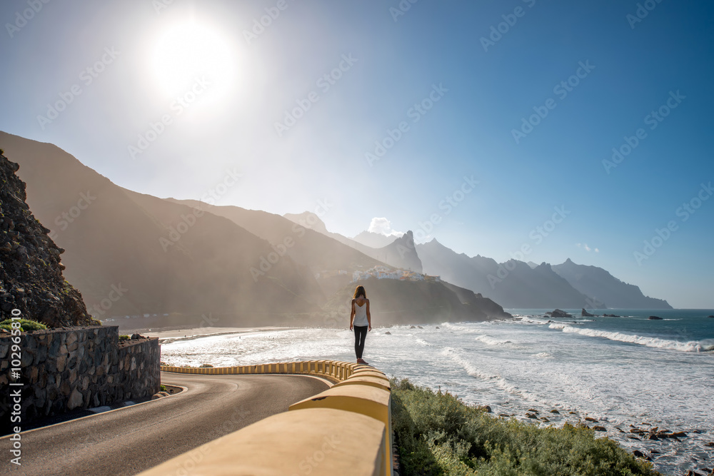 Woman walking near the mountain road