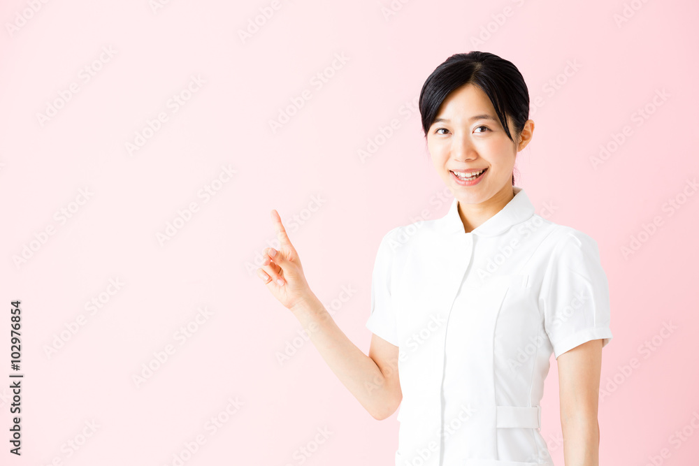 portrait of asian nurse isolated on pink background