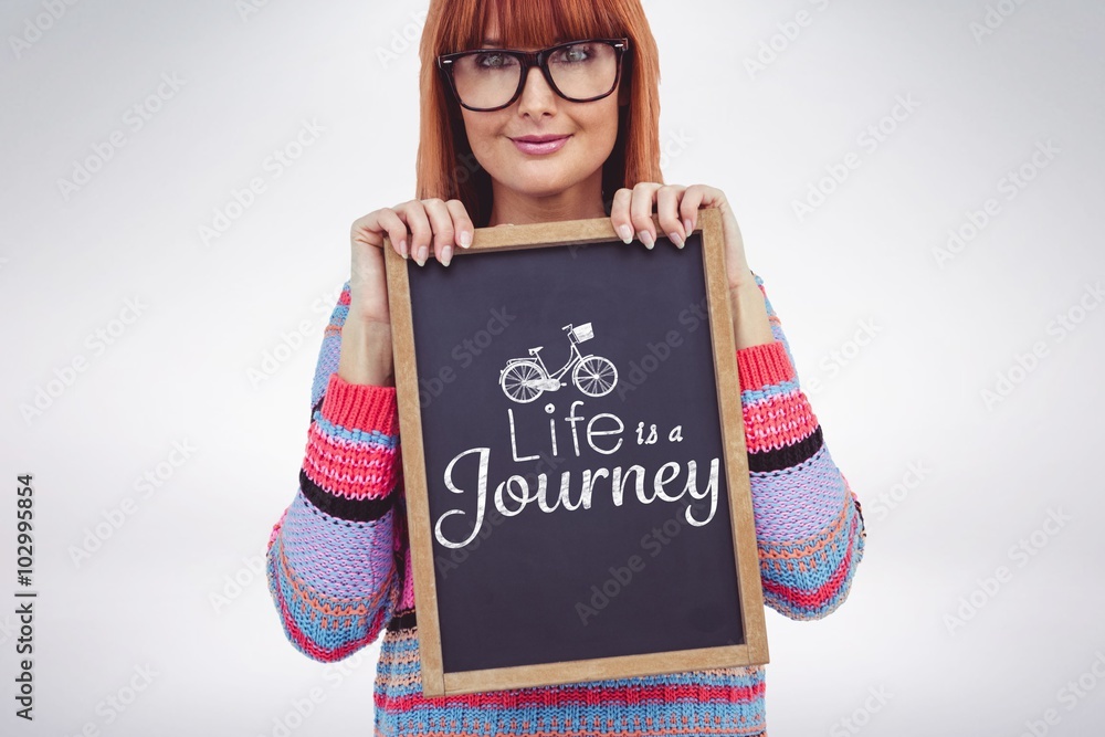 Composite image of smiling hipster woman holding blackboard