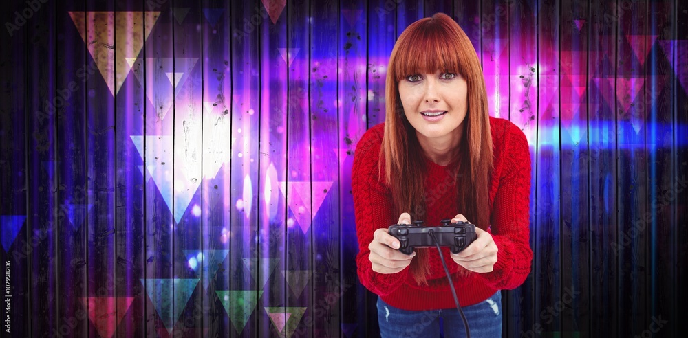 Composite image of smiling hipster woman playing video games