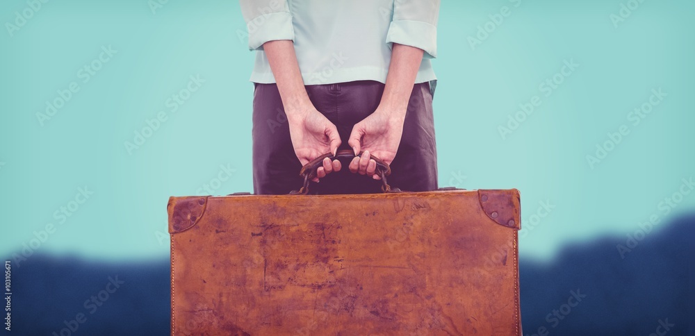 Composite image of rear view of hipster woman holding suitcase