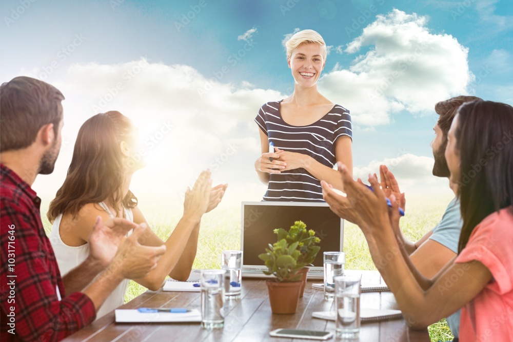 Composite image of colleagues clapping hands in a meeting