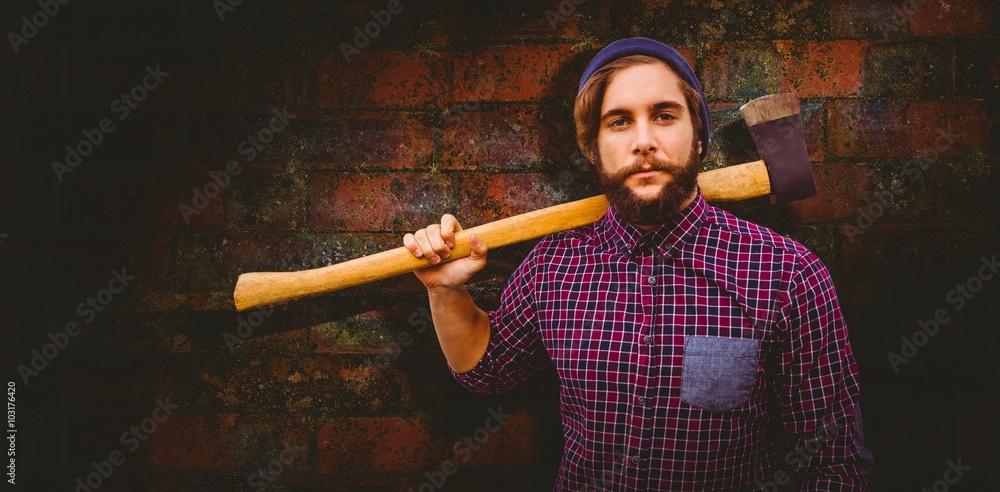 Composite image of hipster holding axe on shoulder