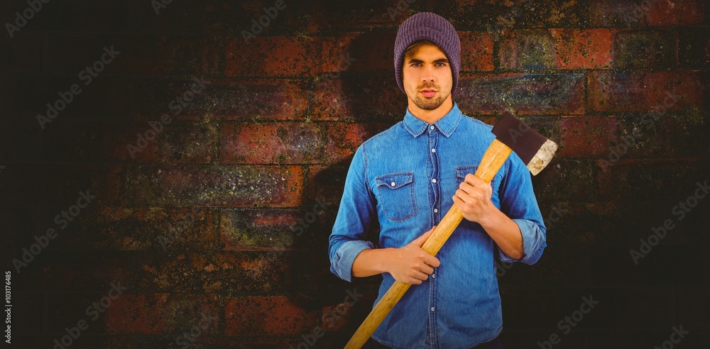 Composite image of portrait of serious hipster holding axe