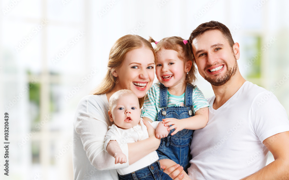 happy family mother, father and children at home