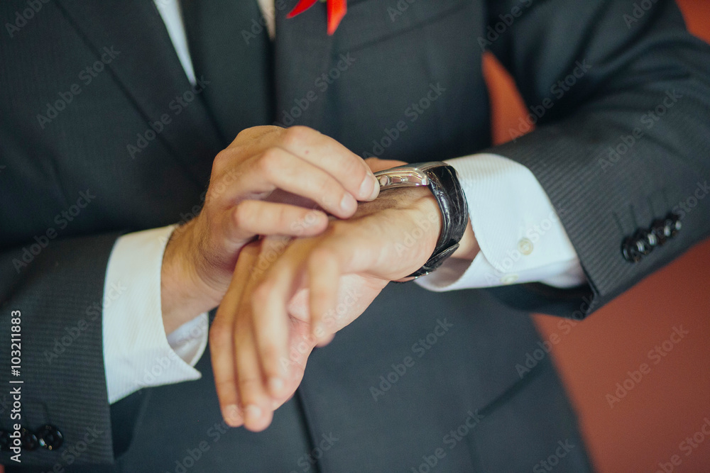 Businessman checking the time on his watch