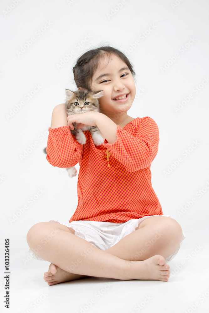 Little Asian girl hugging lovely Persian kitten on isolated