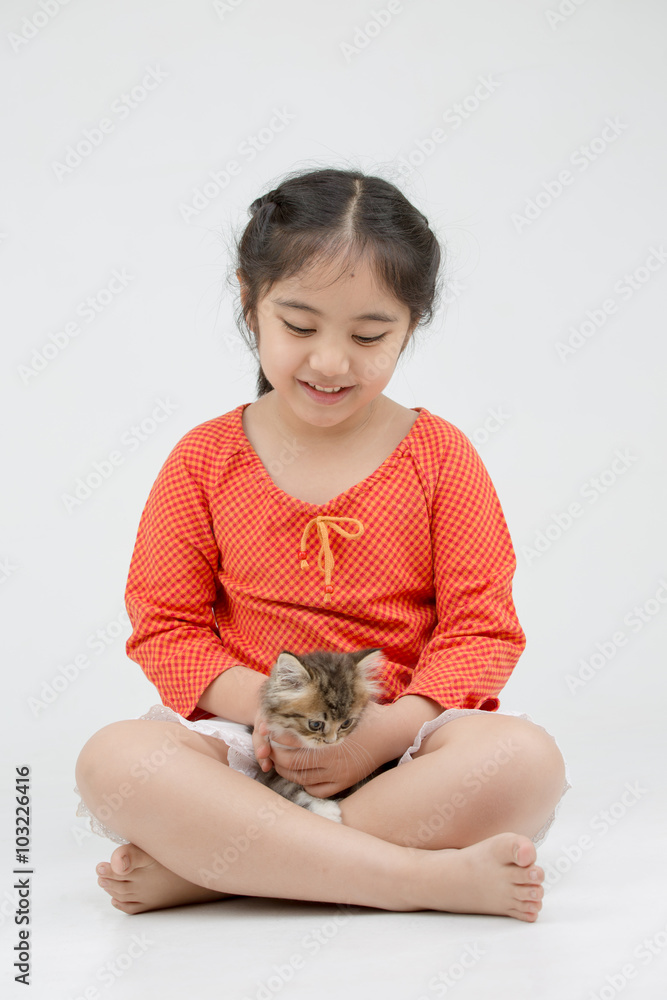 Little Asian girl hugging lovely Persian kitten on isolated