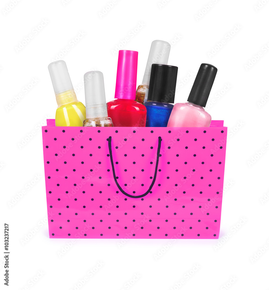 nail polishes in a shopping bag isolatad on white