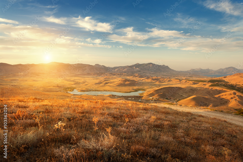 Beautiful view at the mountain valley with cloudy blue sky at sunset in summer. Nature landscape