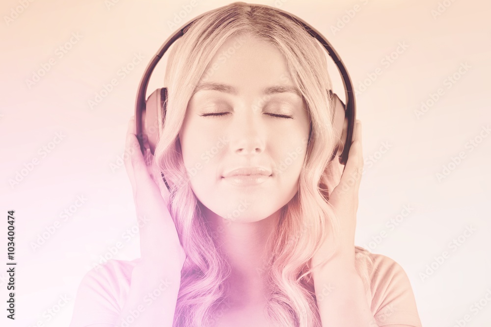 Composite image of close up of a woman listening to music 