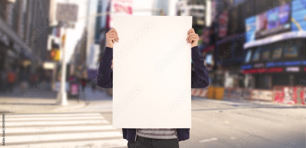 Composite image of man showing billboard in front of face