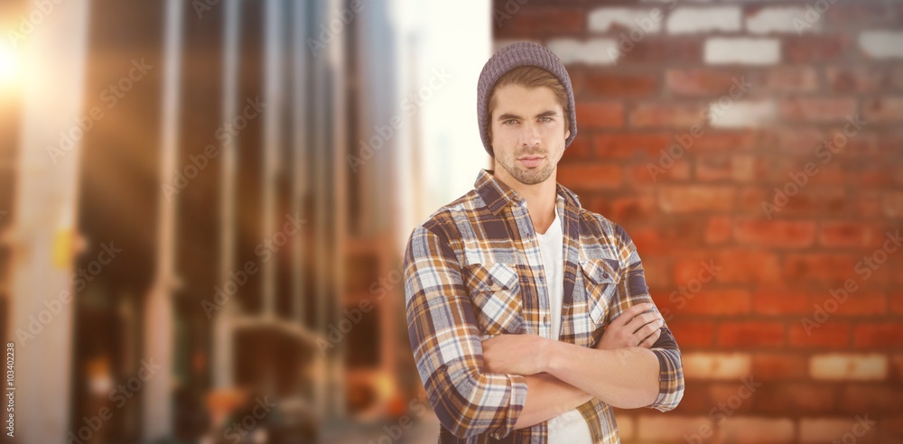 Composite image of confident man with arms crossed