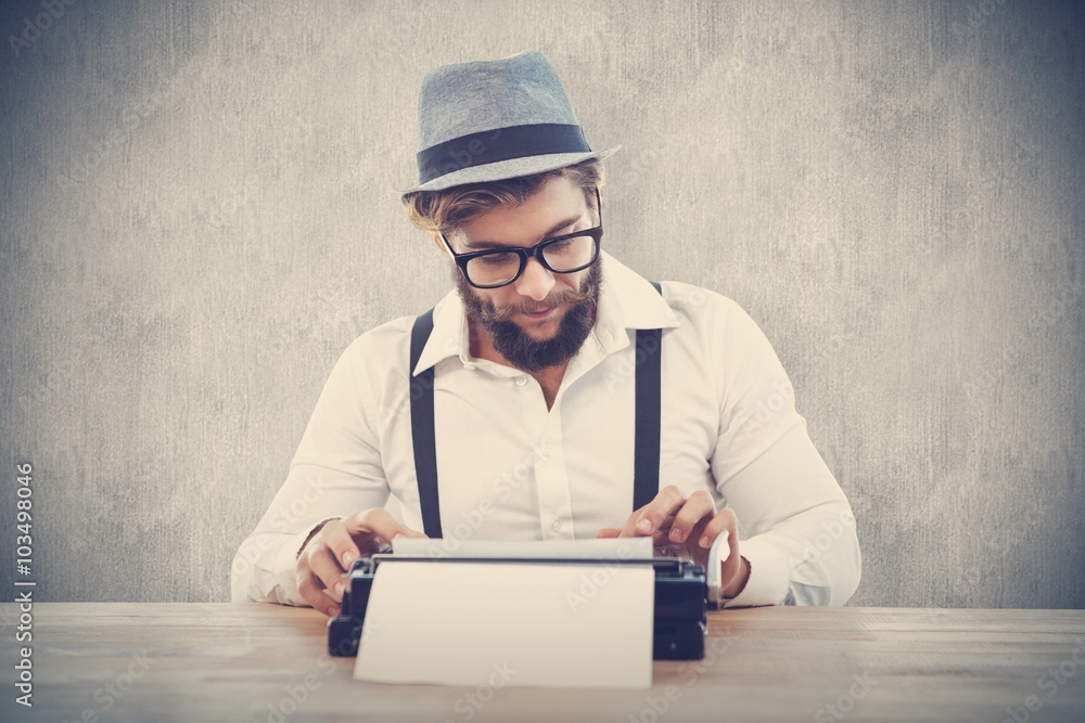 Composite image of hipster wearing eye glasses and hat working