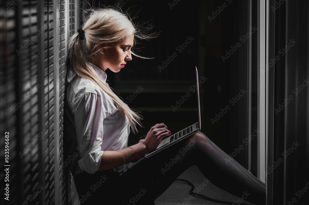 Young engineer businesswoman in server room