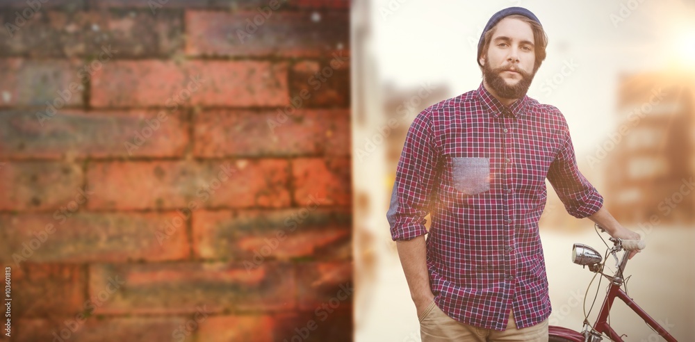 Composite image of portrait of confident hipster with bicycle