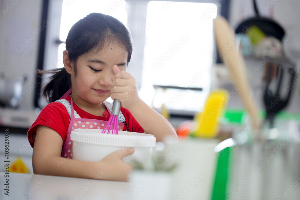 Little Asian cute chef cooking a bakery in kitchen