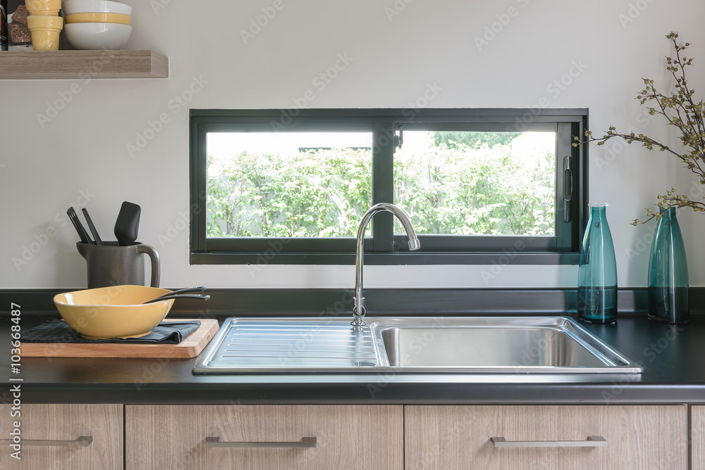 wooden kitchen counter with black granite on top