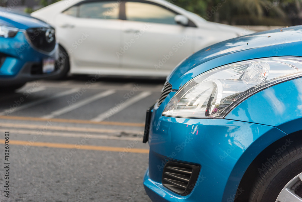 headlight of blue car on street