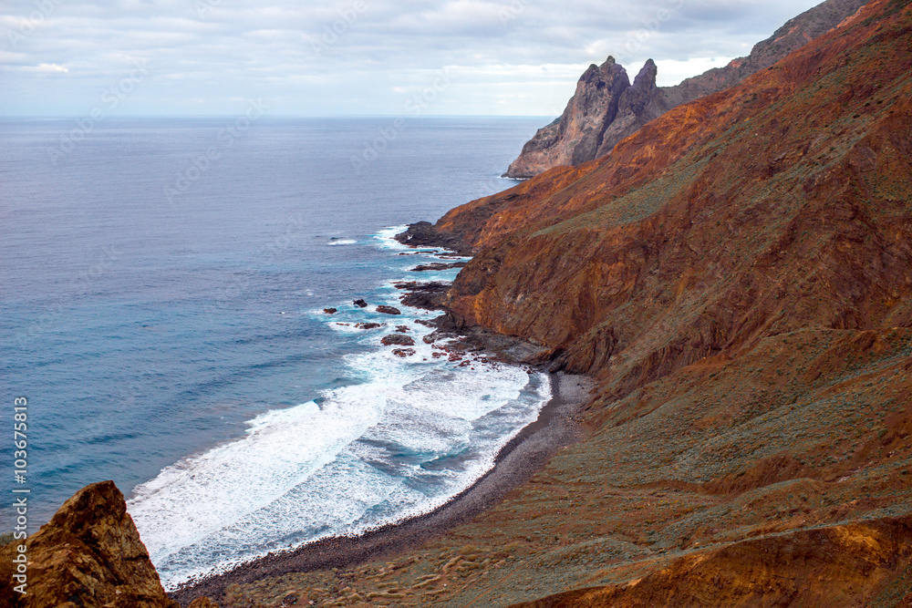 Rocky coastline with stone beach on the western part of La Gomera island near Arguamul village in Sp