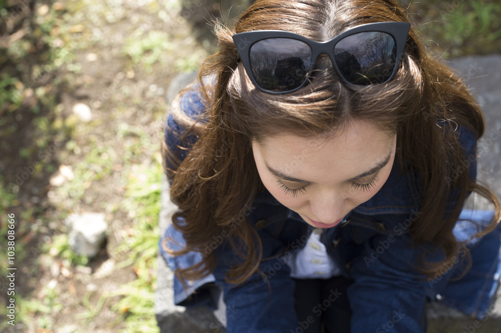 Young women wearing sunglasses on his head