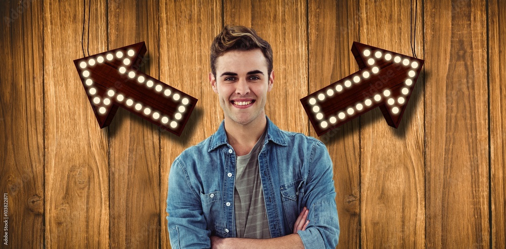 Composite image of smiling creative businessman by his desk