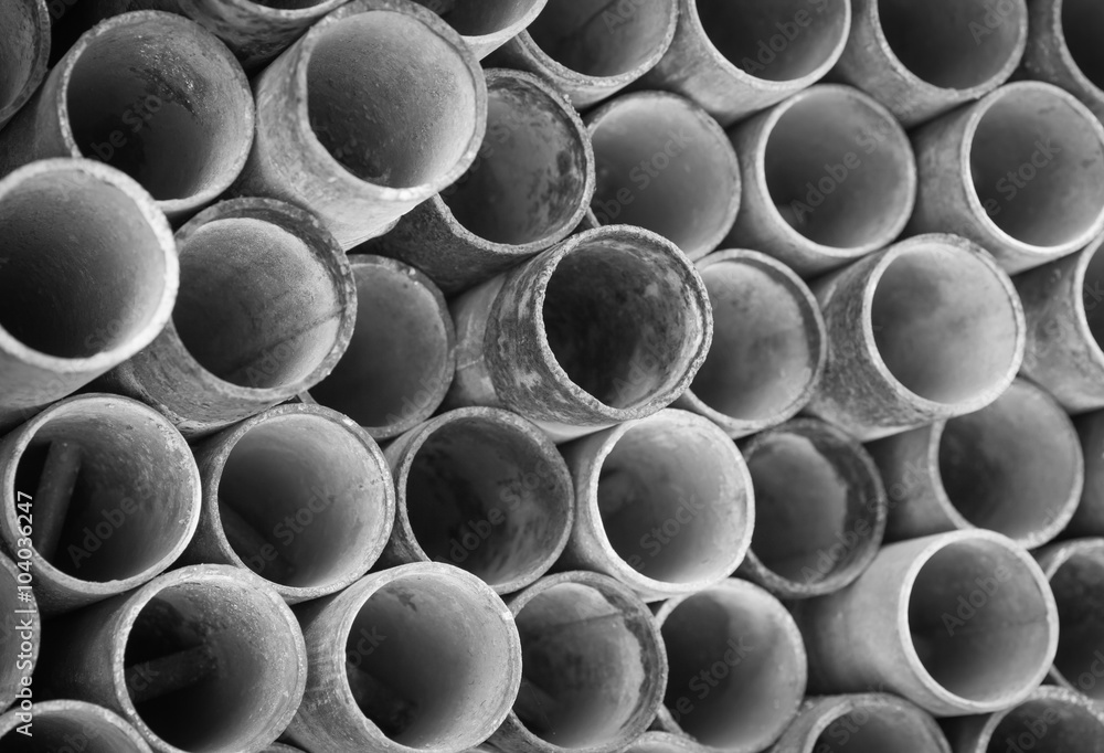 Close - up Stack of construction metal pipes .