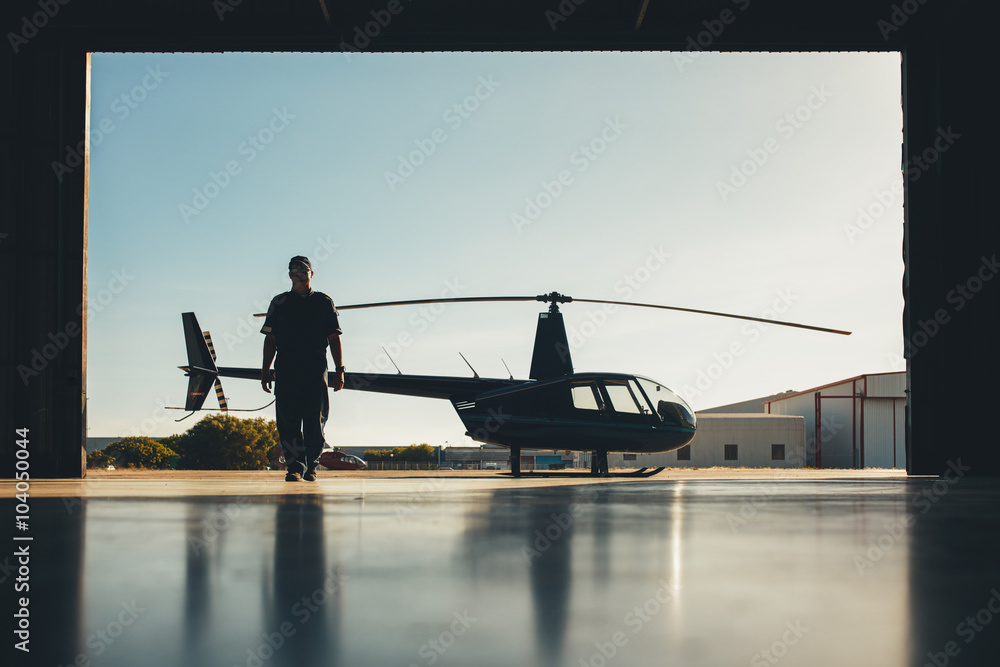 Pilot walking away from helicopter