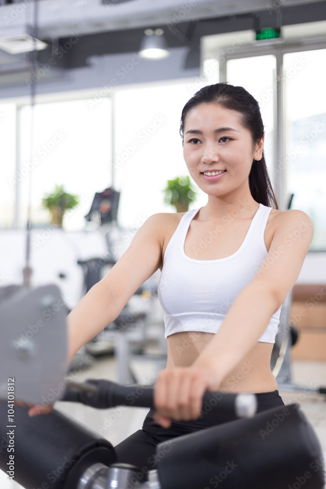 beautiful girl working out in modern gym