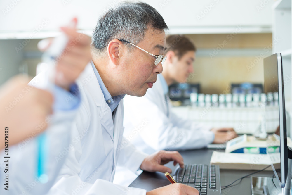 people doing chemical experiment in modern lab