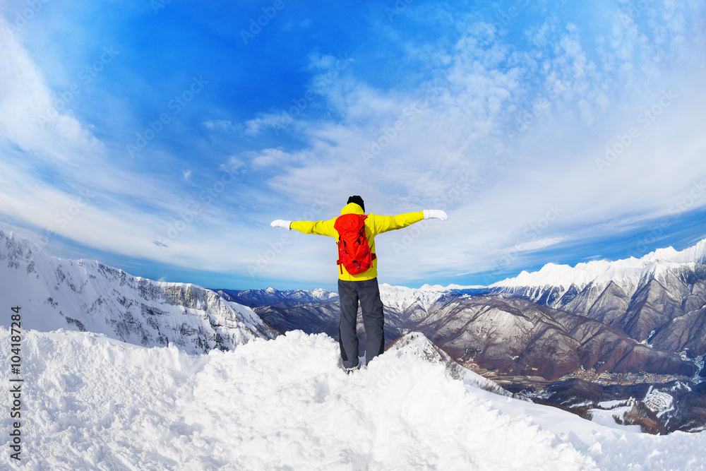 Backpacker stand on top of mountain peak