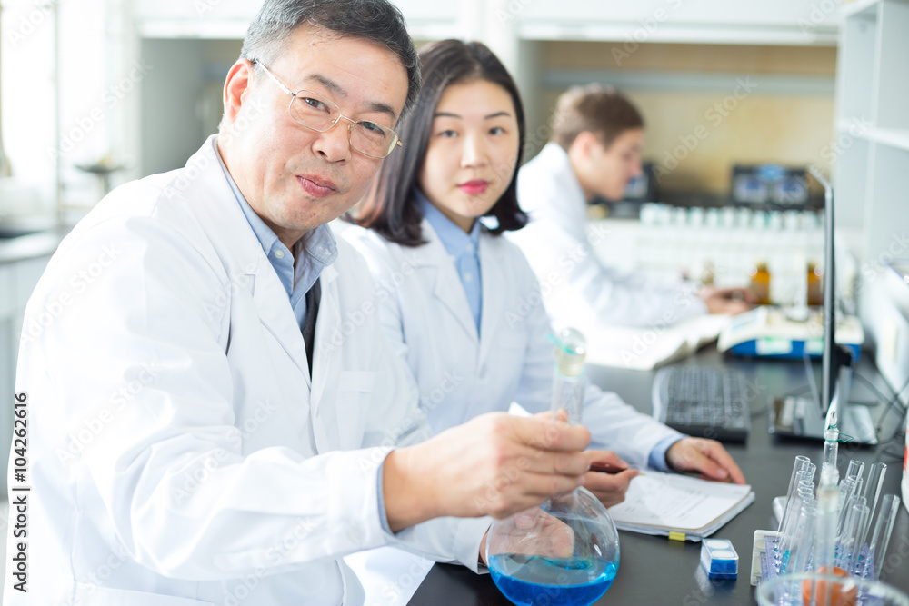 people doing chemical experiment in modern lab