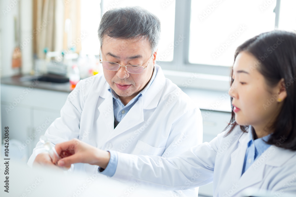 people doing chemical experiment in modern lab