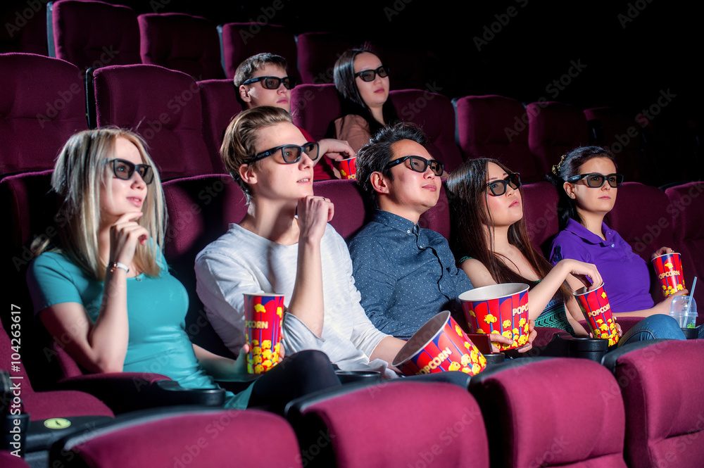 People in the cinema wearing 3d glasses