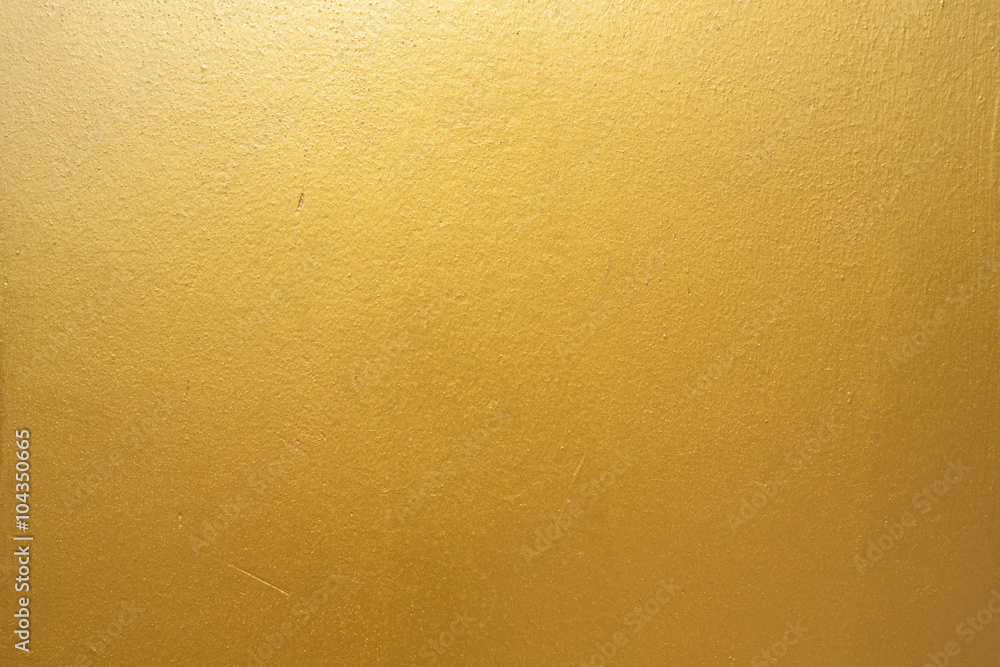 Gold concrete wall on background texture.