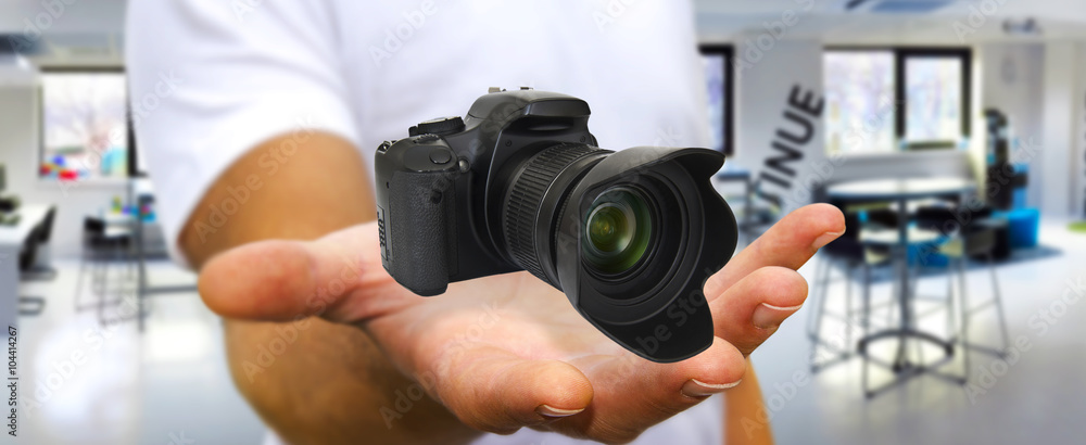 Young man using modern camera