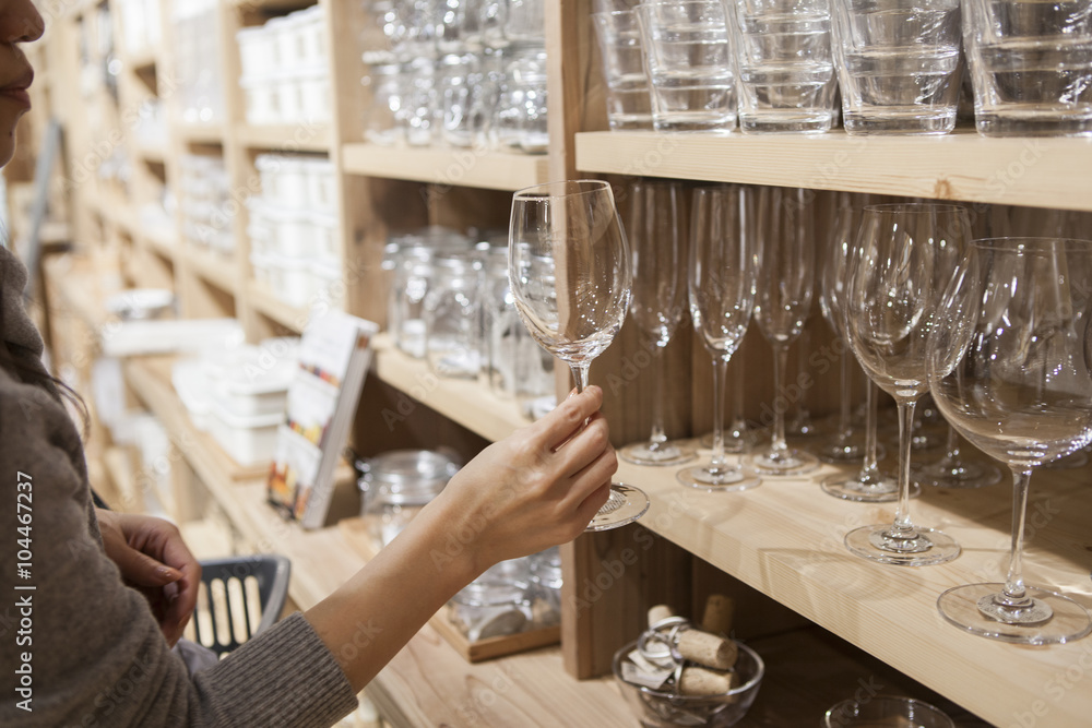 Women have seen a glass of wine in the tableware shop