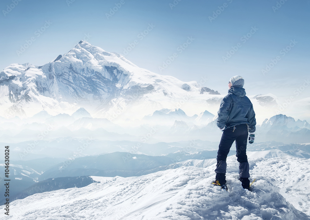 Tourist on the peak of high rocks. Sport and active life concept.