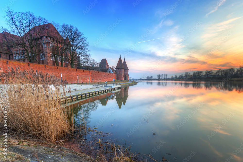 The Castle of the Teutonic Order in Malbork at sunset, Poland